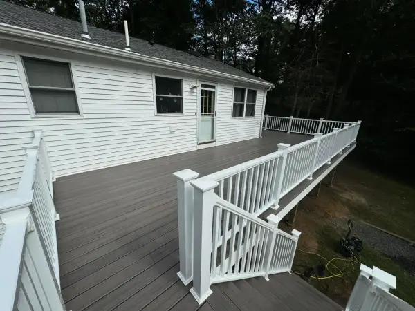 Finished wrap-around composite deck surrounding patio pool entry