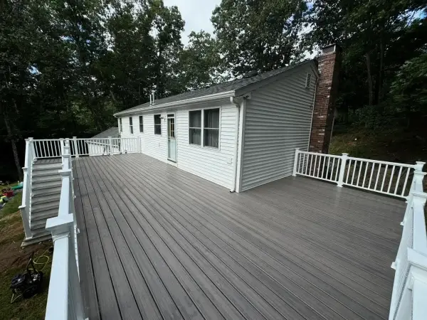 Modern backyard deck showcasing composite boards and dark metal railings